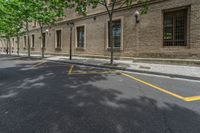 the side walk and walkway of a building is marked with markings for parking spaces below