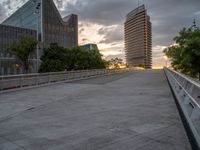 there is a large cement bridge over the road on a cloudy day with tall buildings in the background