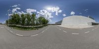 this fisheye lens shows the reflection of a man skateboarding down a street in a building