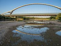 there are two very long bridges that are above the river shore at dusk here, and you can see how close them are