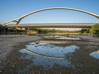 there are two very long bridges that are above the river shore at dusk here, and you can see how close them are