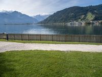 view of lake borro and hills in distance of park area with benches and gated grass