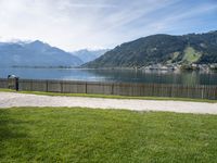 view of lake borro and hills in distance of park area with benches and gated grass