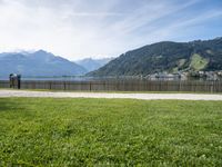 view of lake borro and hills in distance of park area with benches and gated grass