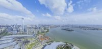 an aerial view of a city across the water of a river and buildings along side