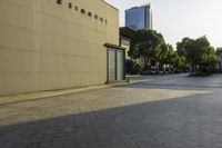 an empty street with cars and tall buildings in the backrount of the image