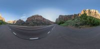 the 360 - view mirror image has a curved road at the center of the photo