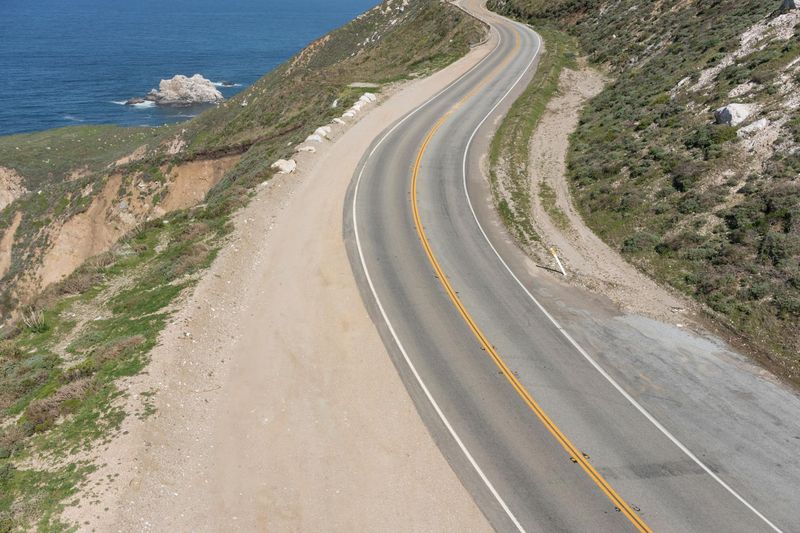 Aerial view of a winding road along a coastal line HDRi Maps and Backplates
