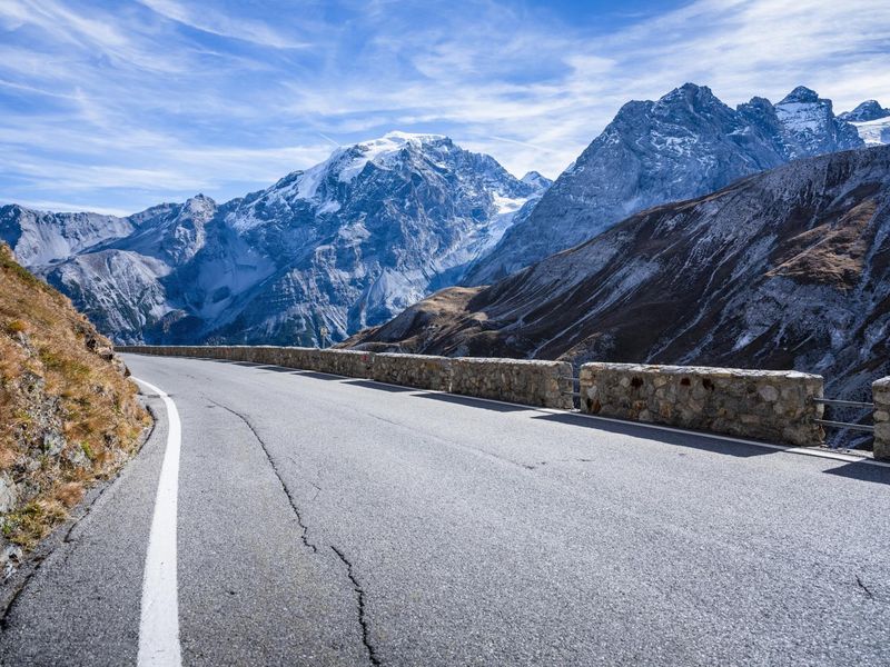 Cyclist Riding on Scenic Road through Italian Alps HDRi Maps and Backplates